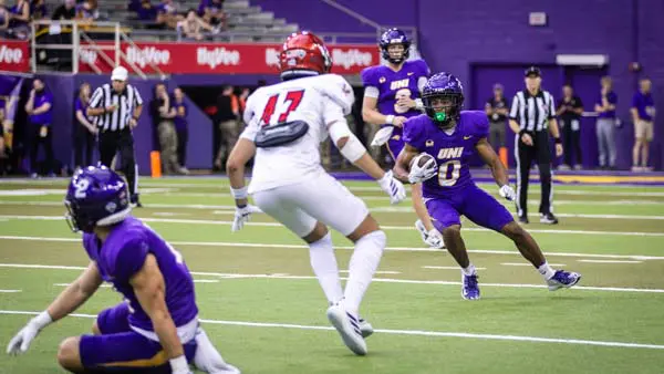 football players running on the field